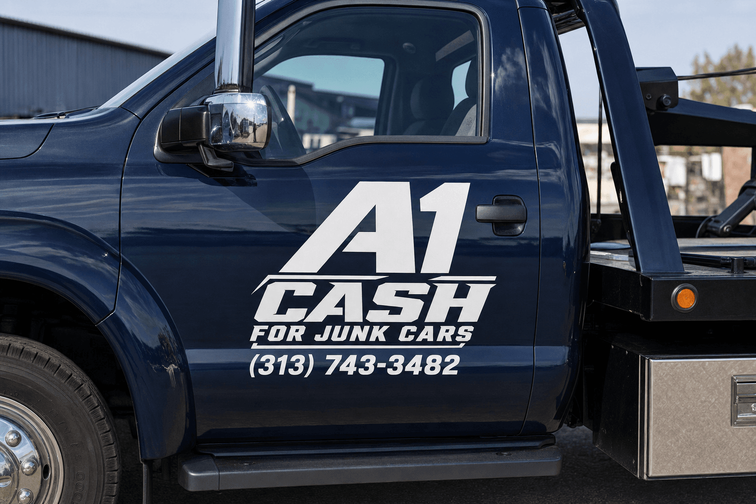 Tow truck lifting a car onto a flatbed in front of a house